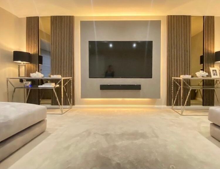 Bespoke fitted bedroom with slatted feature panels and glass side tables
