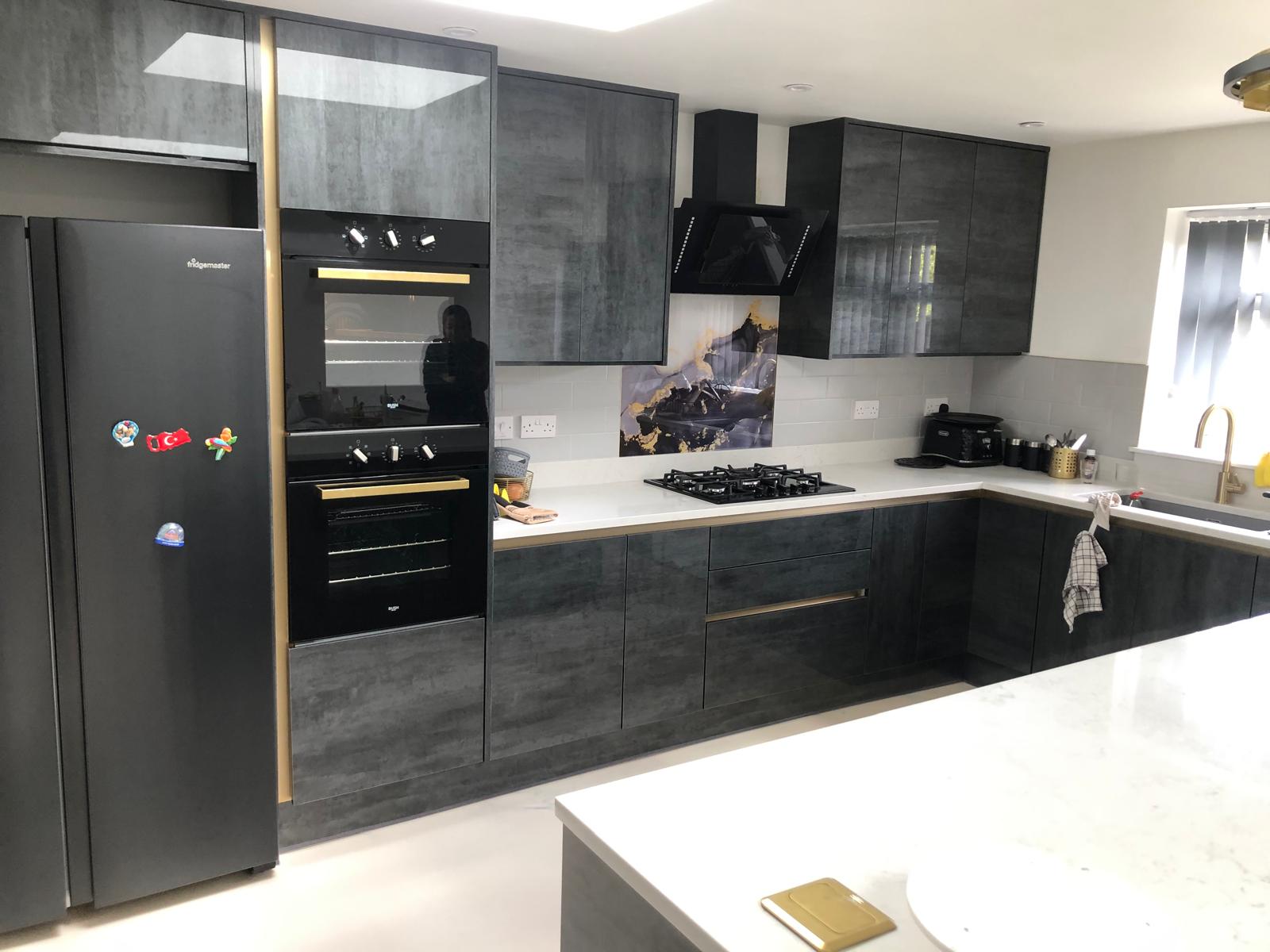 Grey gloss kitchen with marble-effect feature splashback