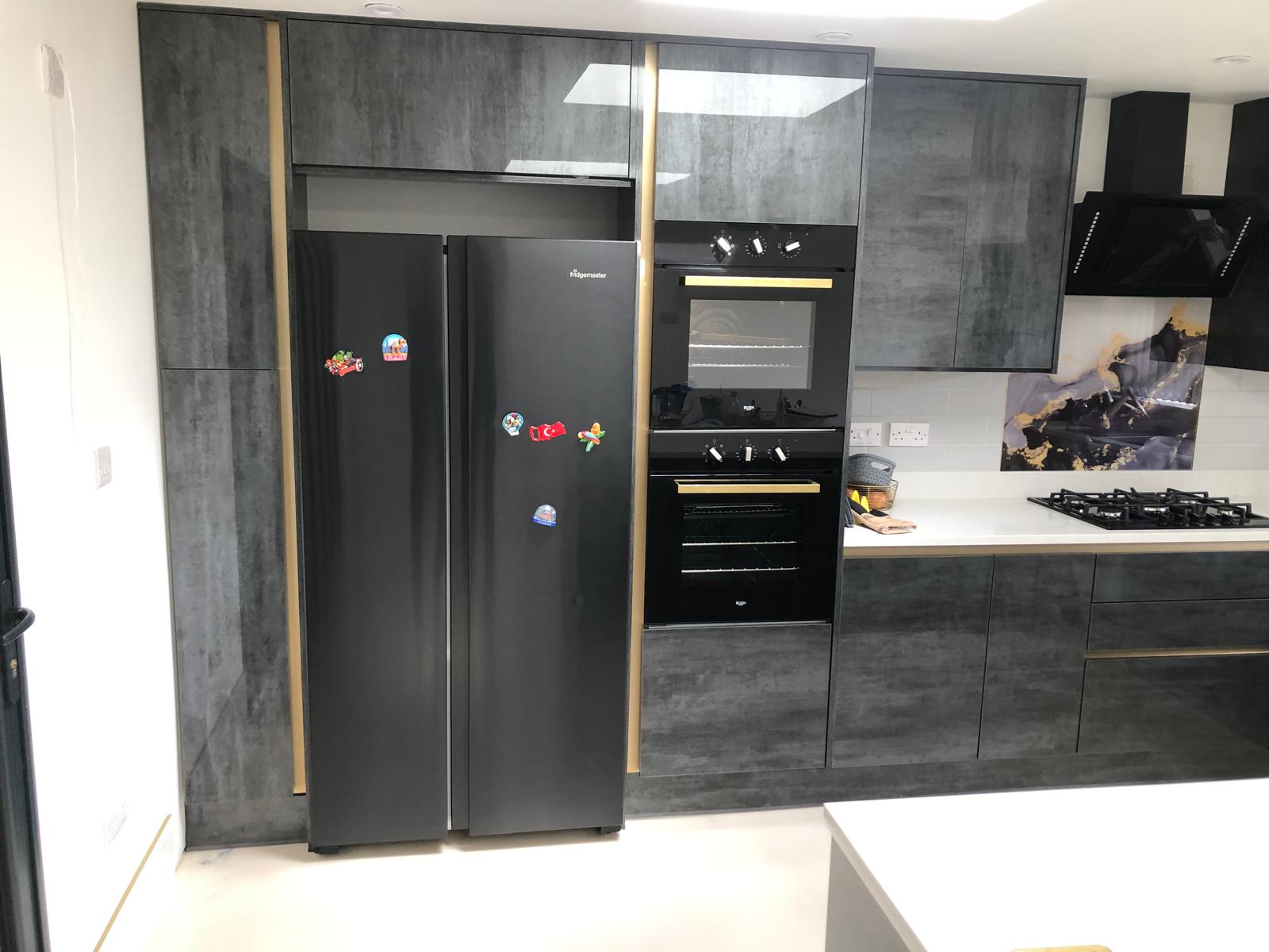 Dark grey kitchen with brass detailing