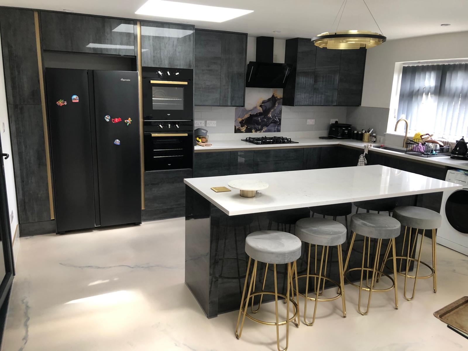 Dark grey gloss kitchen with quartz island and brass hairpin stools