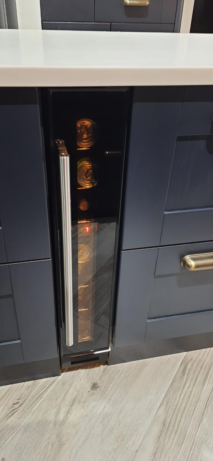 Integrated wine cooler in navy kitchen island