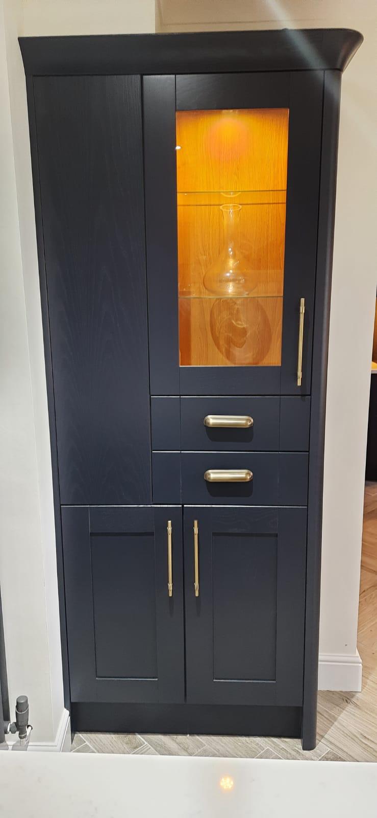 Tall navy display cabinet with brass handles