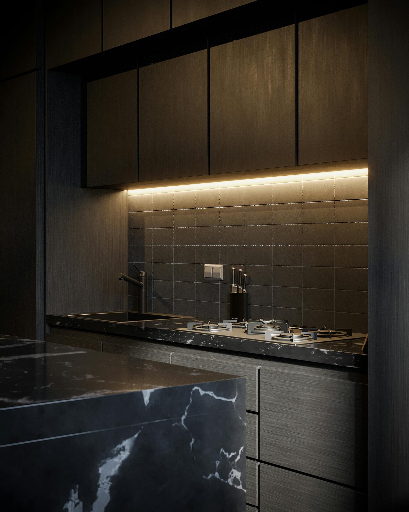 Moody dark kitchen with black marble worktops and bronze cabinetry
